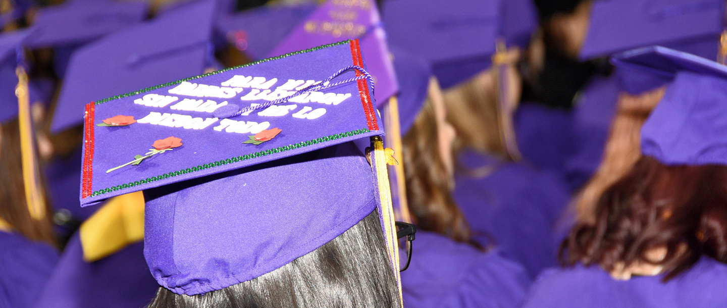 graduate with roses on the top of their cap