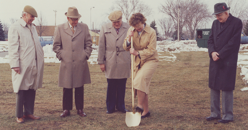 a group of people digging in the grass