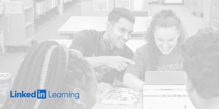 Grayscale image of students studying together and smiling at their laptops. Blue LinkedIn Learning Logo.