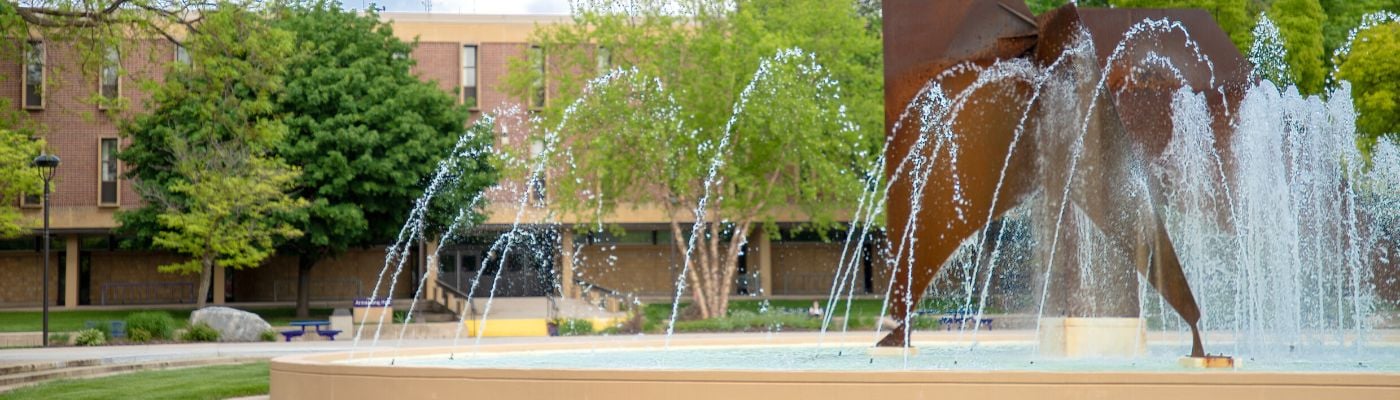 Photo of the campus fountain outside the Centennial Student Union in the summer
