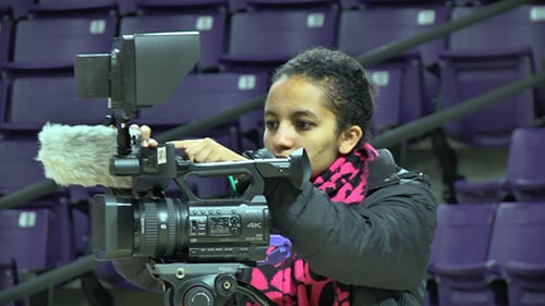 Student operating a camera