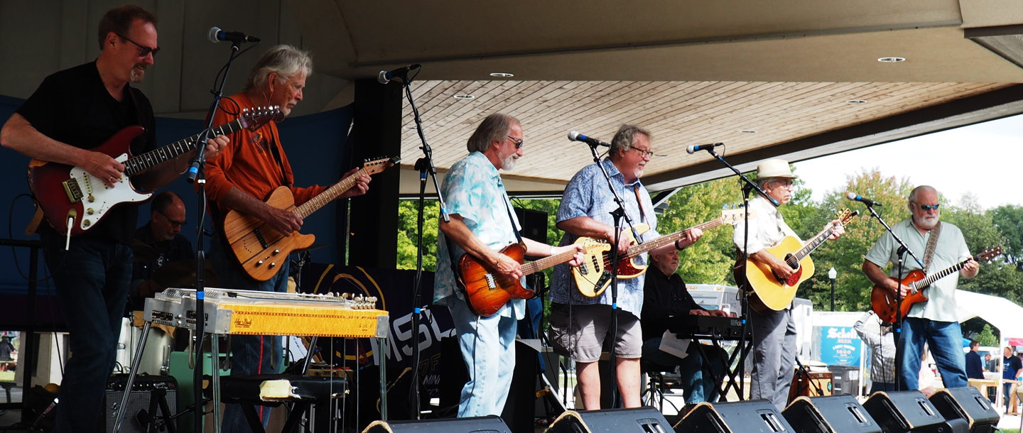 The City Mouse band performing on a stage outside during a musical event