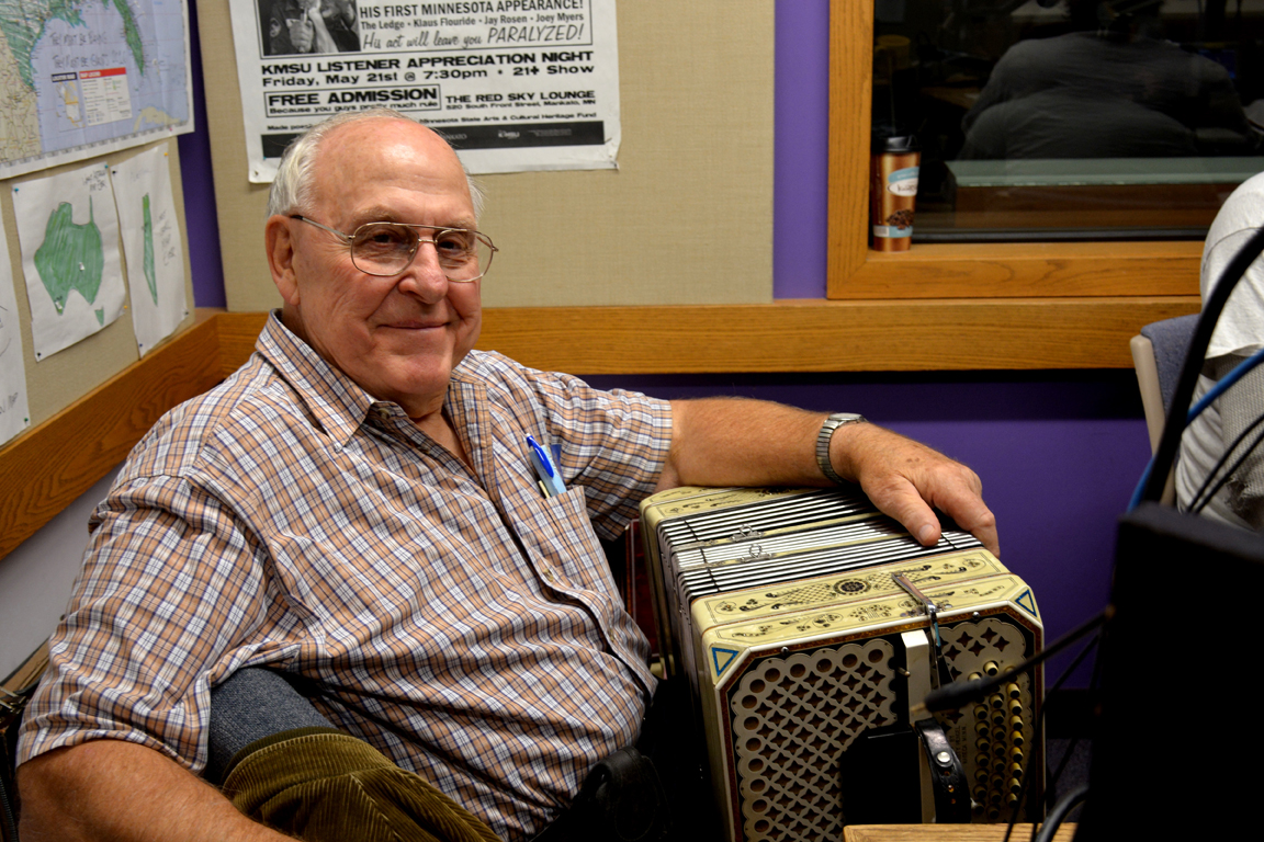 a person sitting in a chair with an accordion