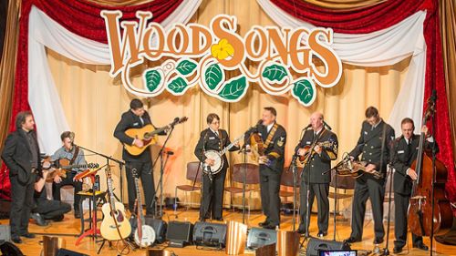 Grassroots musicians playing on a stage at the WoodSongs Old-Time Radio Hour show