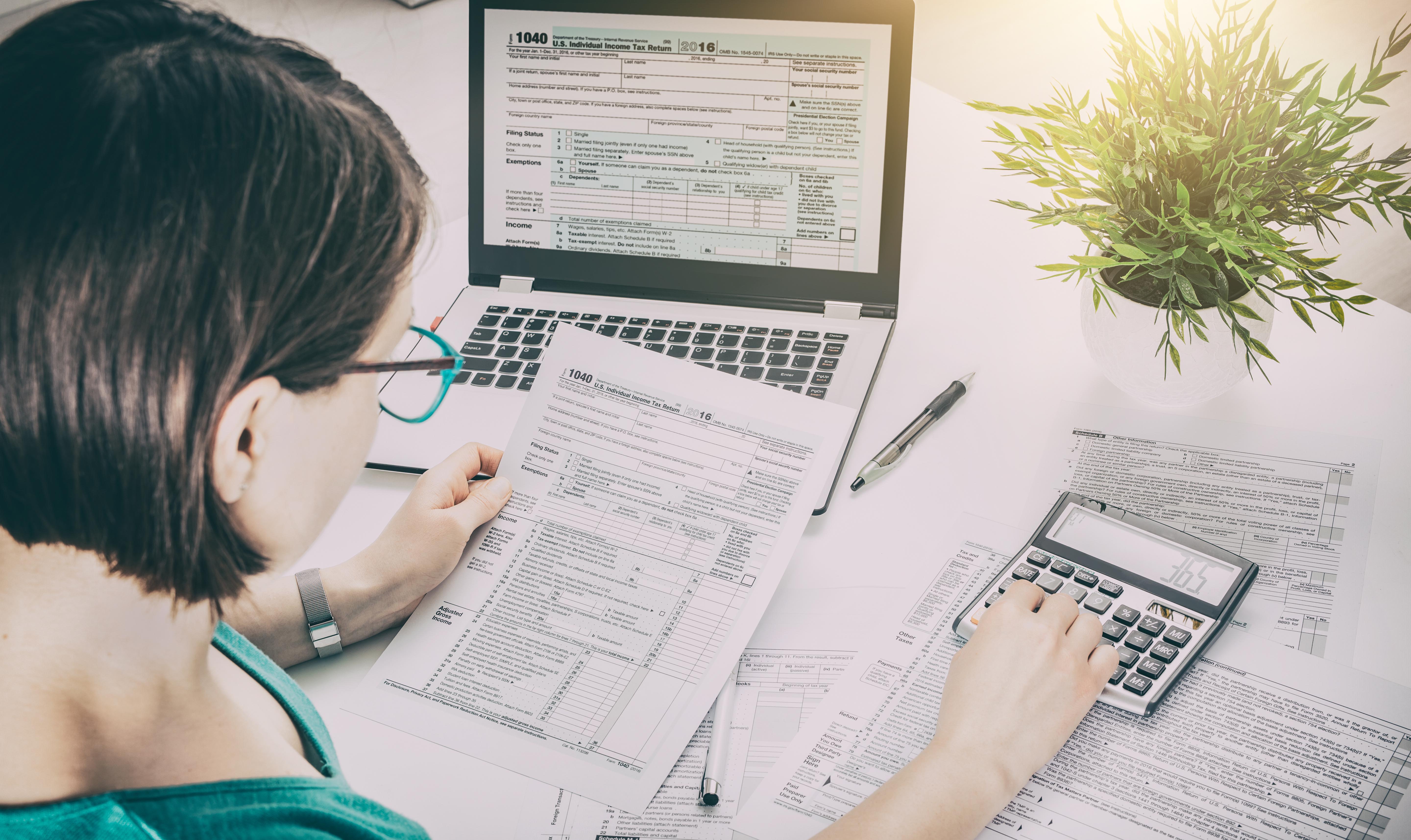 image of female working on tax preparation