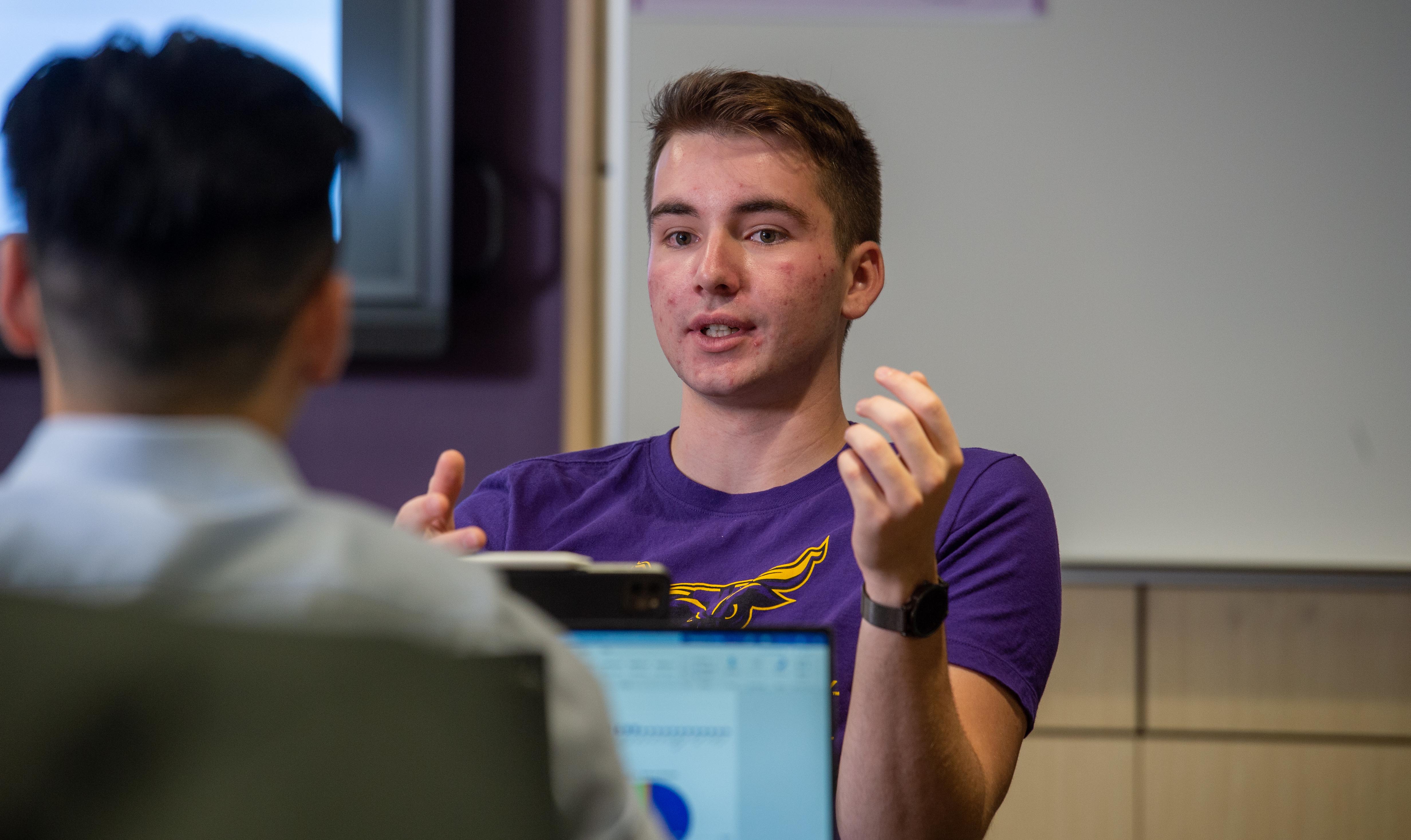 image of two students with graphs