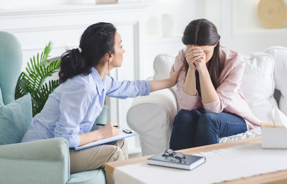 Upset women talking to counselor.