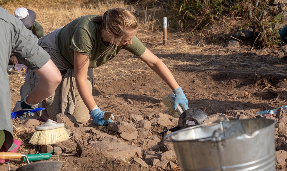 Woman digging in the ground.