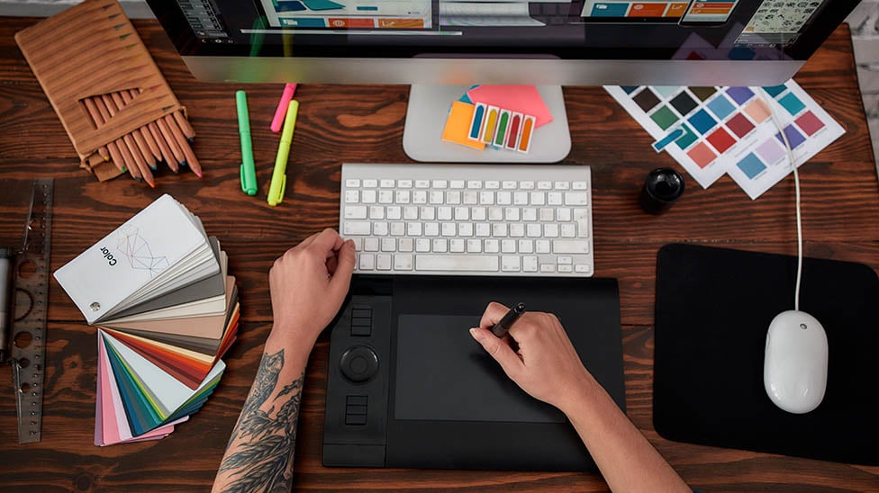 aerial view of a graphic design student drawing with color swatches