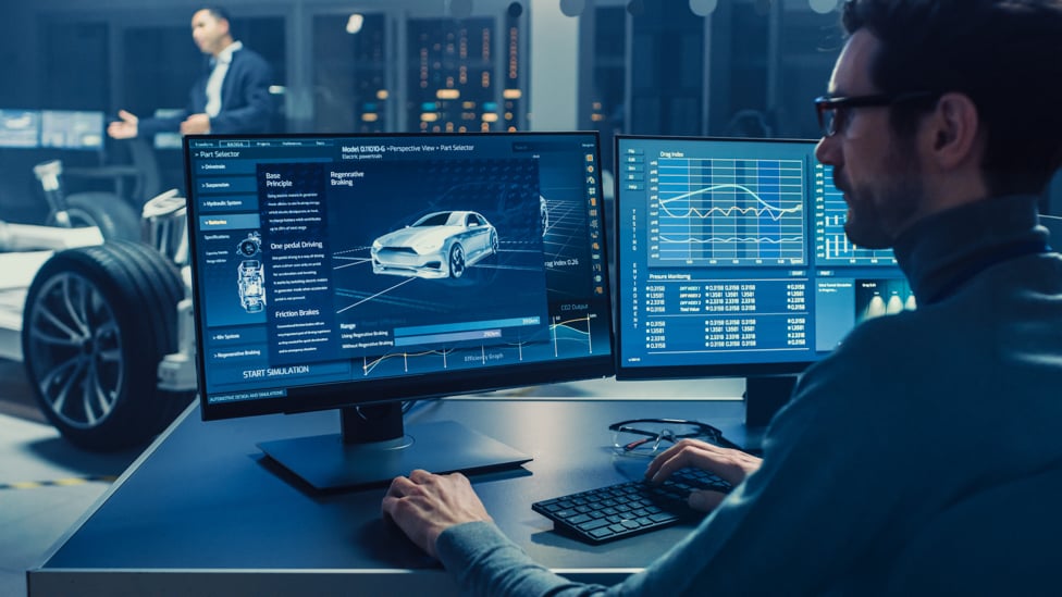 Automotive engineer designer working on computer designing a car.