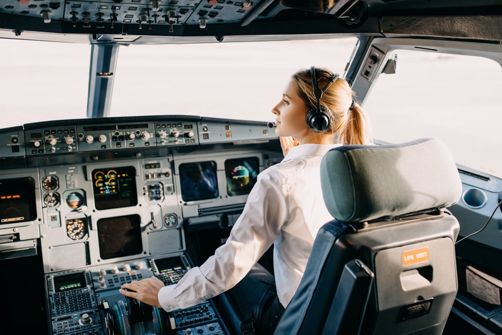 Woman pilot in the airplane cockpit getting ready to fly.