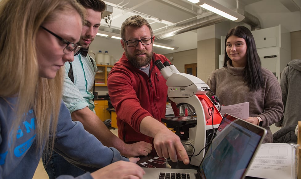 image of professor showing students how to conduct undergraduate research