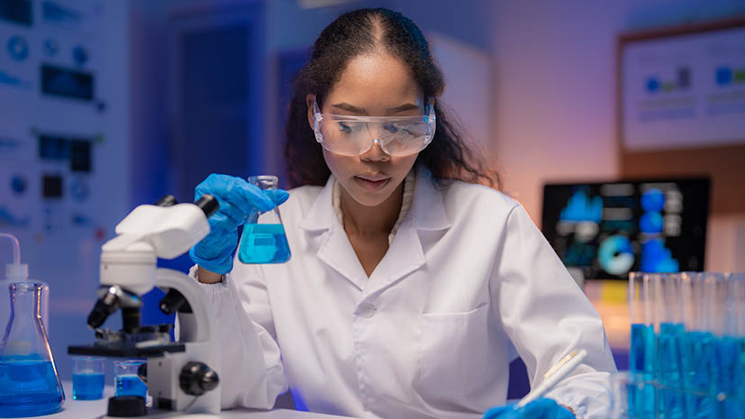 student in a lab using technology for finding biochemical characteristics of an organism