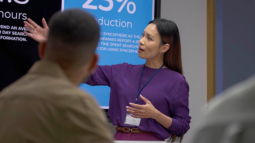 business woman giving a presentation and pointing to the screen