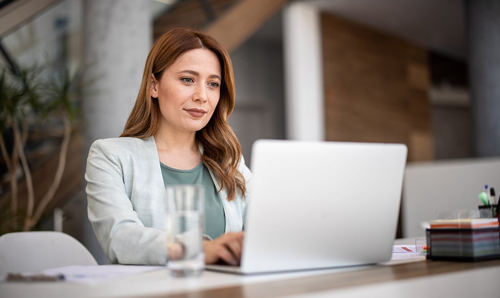 Woman working on laptop.