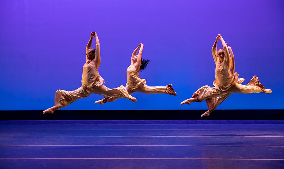 Three student dancers on dancing on stage at MSU