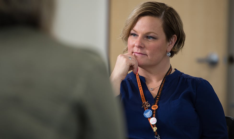 sitting professor deeply focused on students question