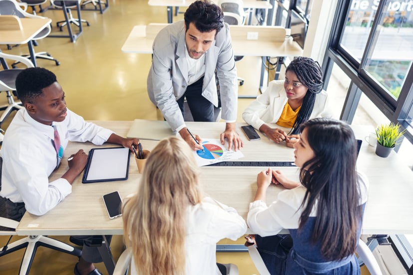 Group of leadership talking around a table.