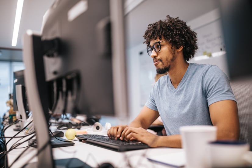 Man typing on computer.