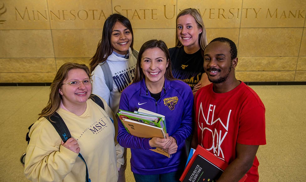 students on campus posing in a group