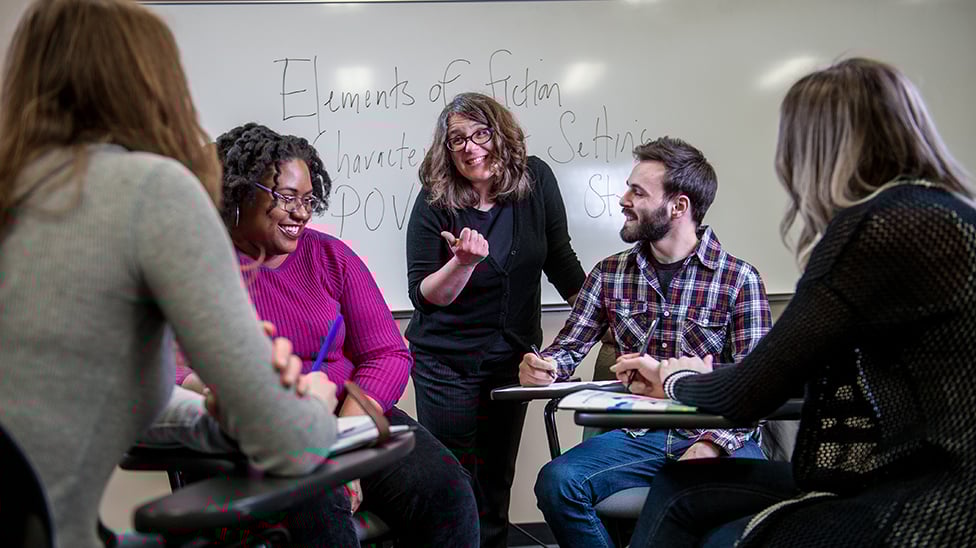 Professor working with a group of students during class