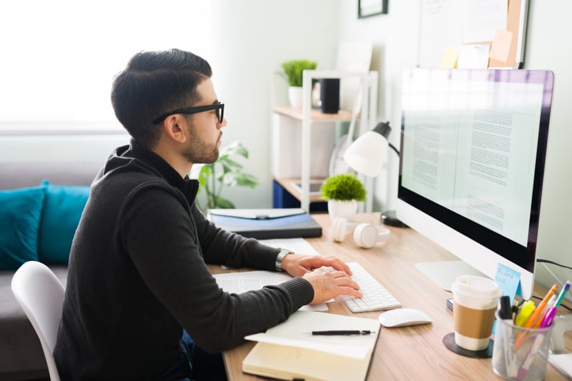 Man typing on a computer.