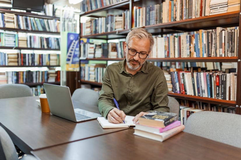 Man writing in notebook.
