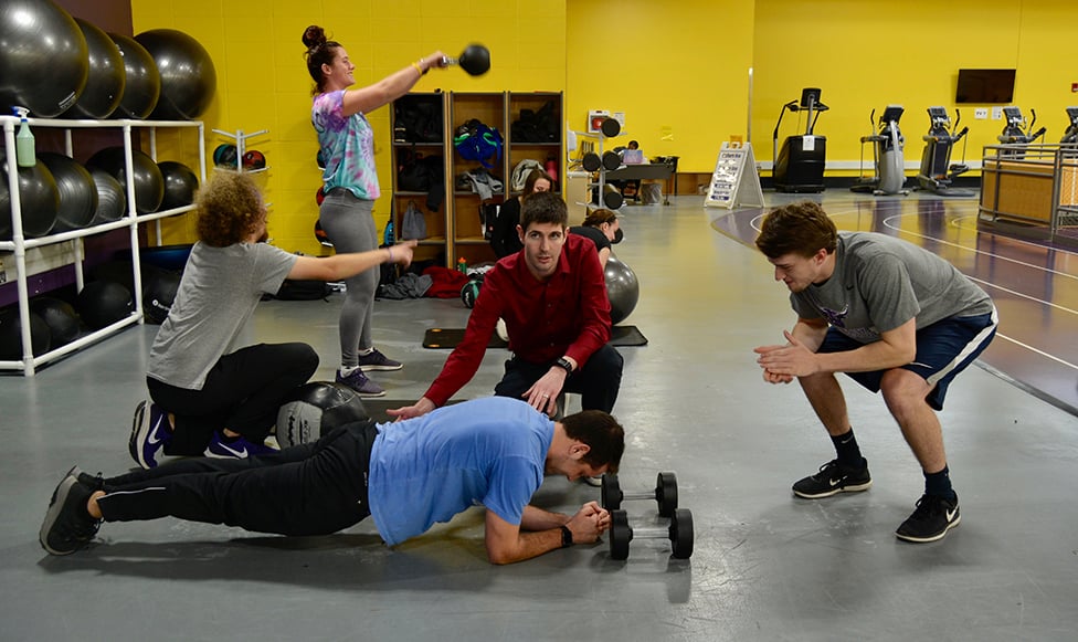students working out in weight room