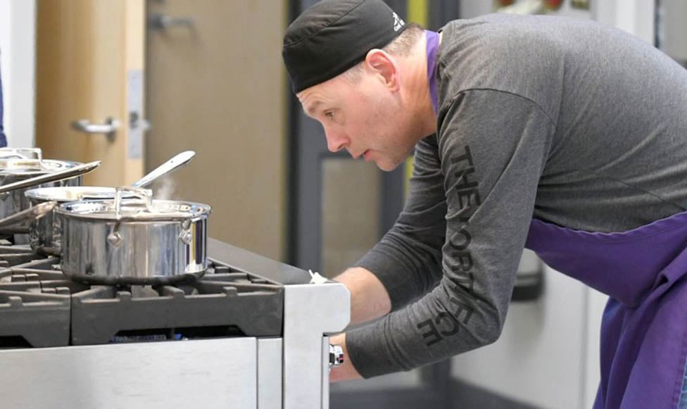 student getting something out of the state of the art oven in the FCS food labs