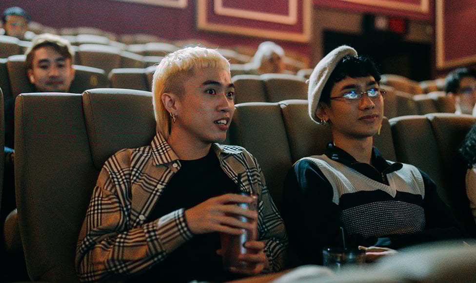 students in a theatre watching something on stage