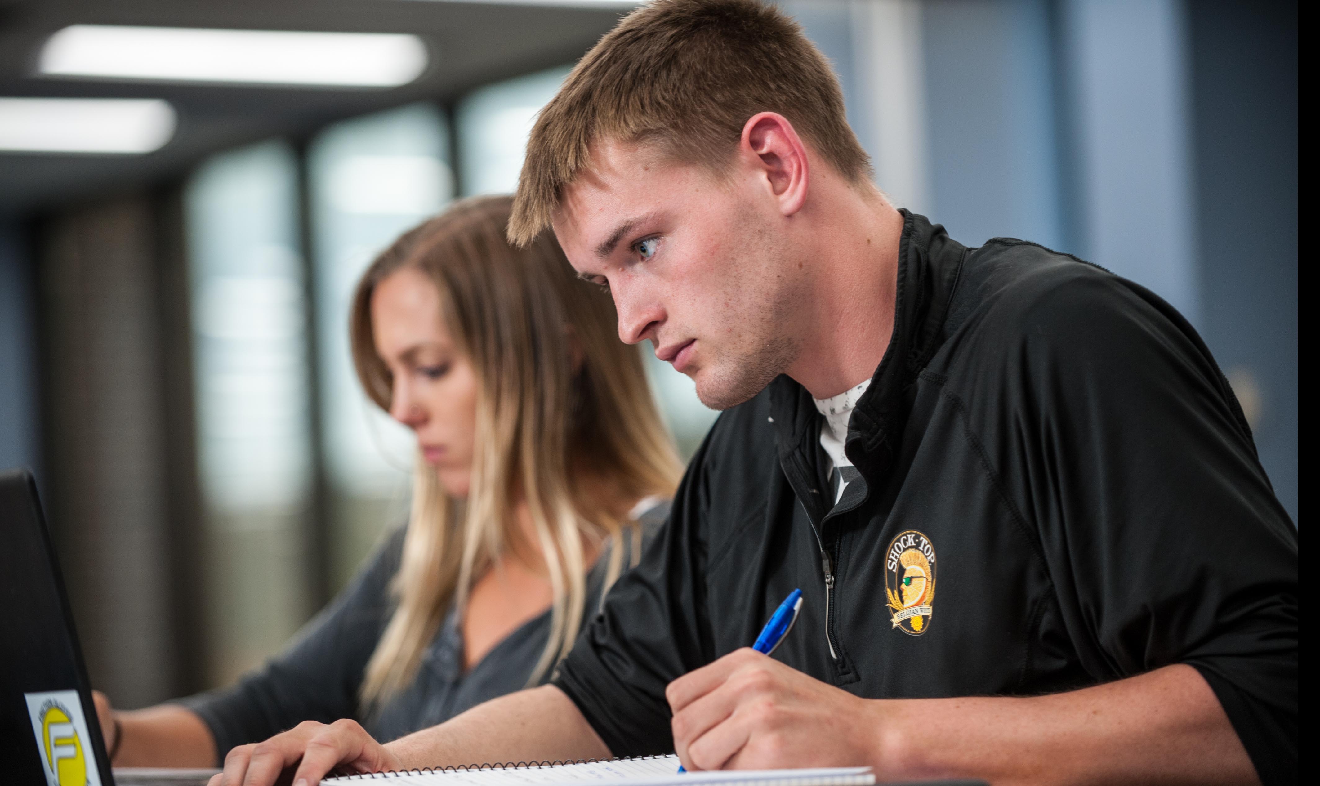 male and female students working on computer