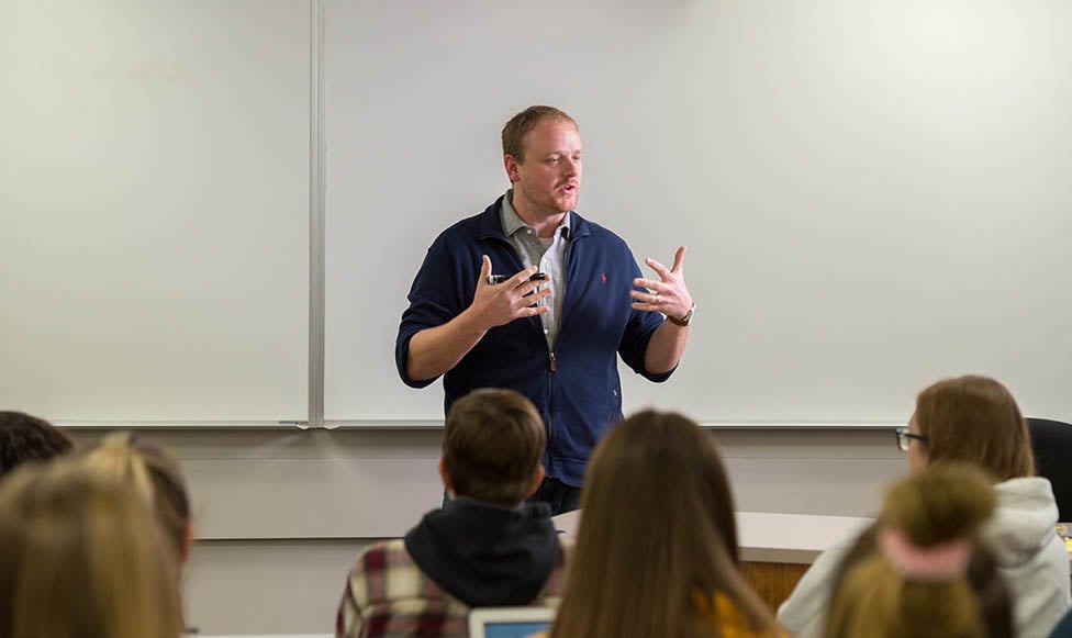 Professor in the front of the classroom giving a lecture