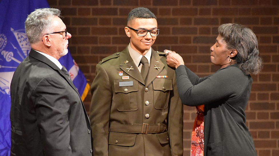 parents pinning their ROTC son at a ceremony