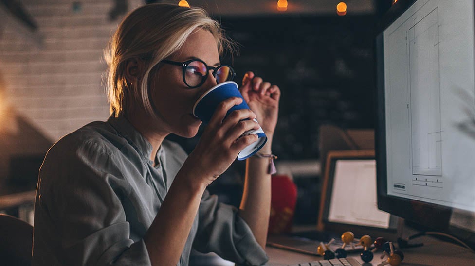 Female sitting at a desk and working on the computer