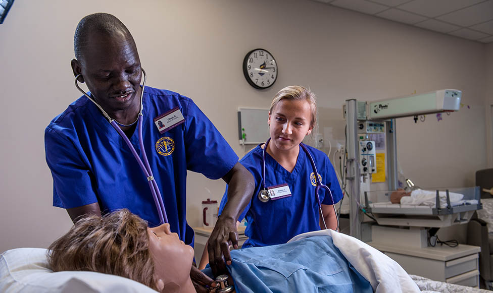 nursing educator and nursing student working in a simulation lab