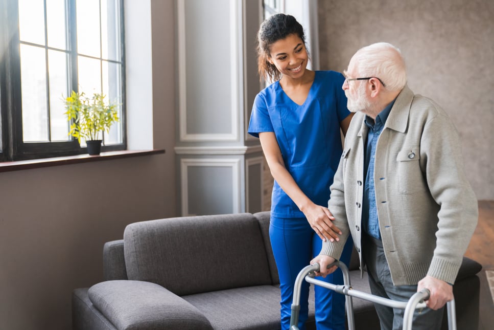 Nursing helping elderly person.