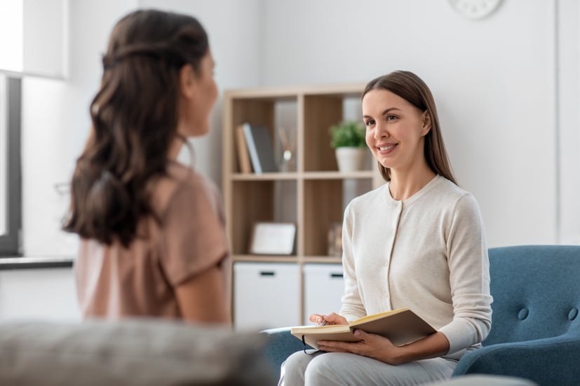 Women talking to another women in a therapy session. 
