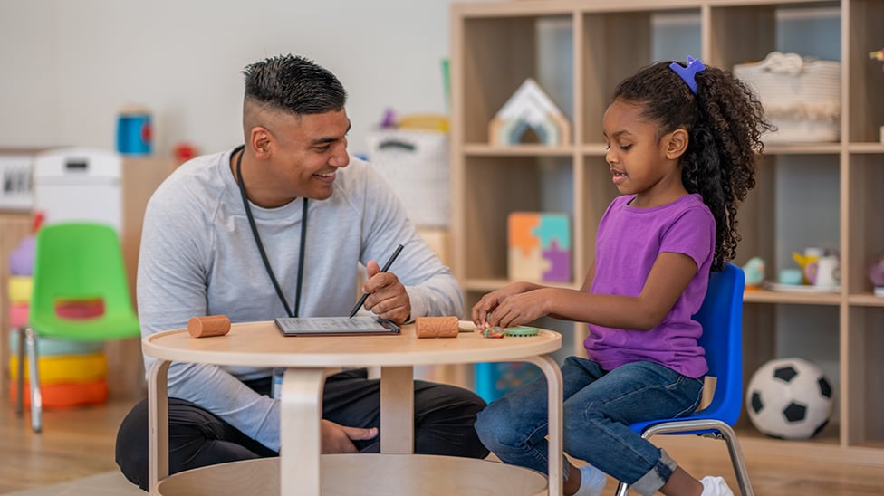 a person and a child sitting at a table