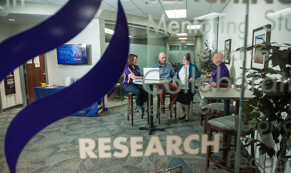 four faculty meeting together