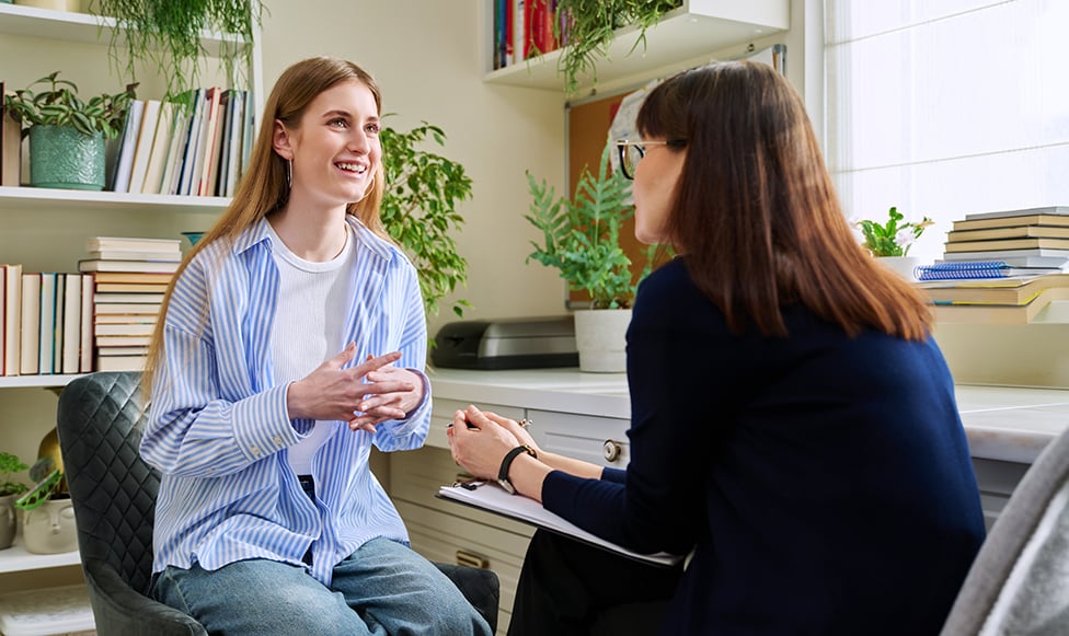advisor and student in an office talking with each other