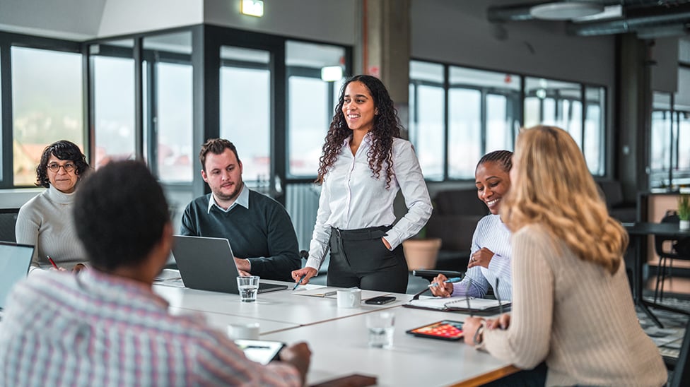 Female giving a presentation in a group meeting