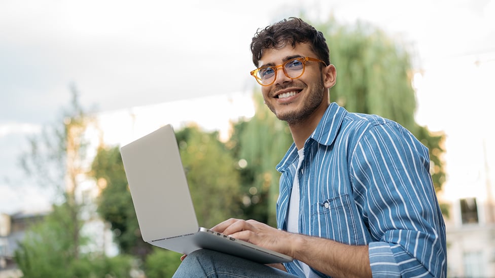 student on a laptop outside