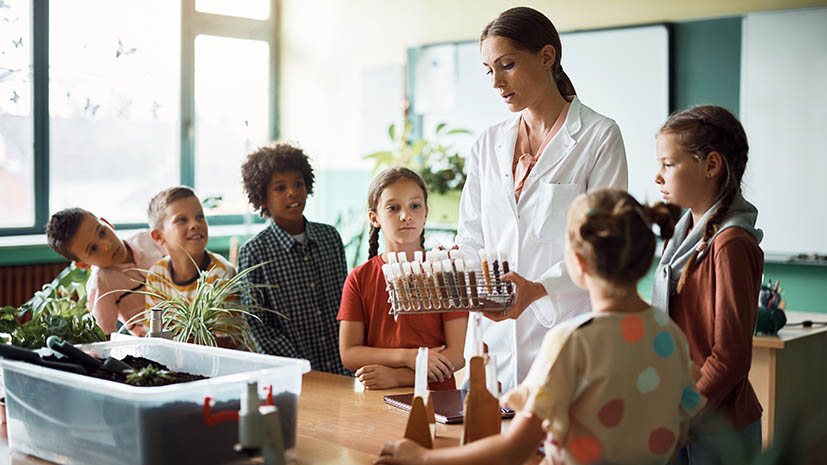 science teacher showing elementary age students plants