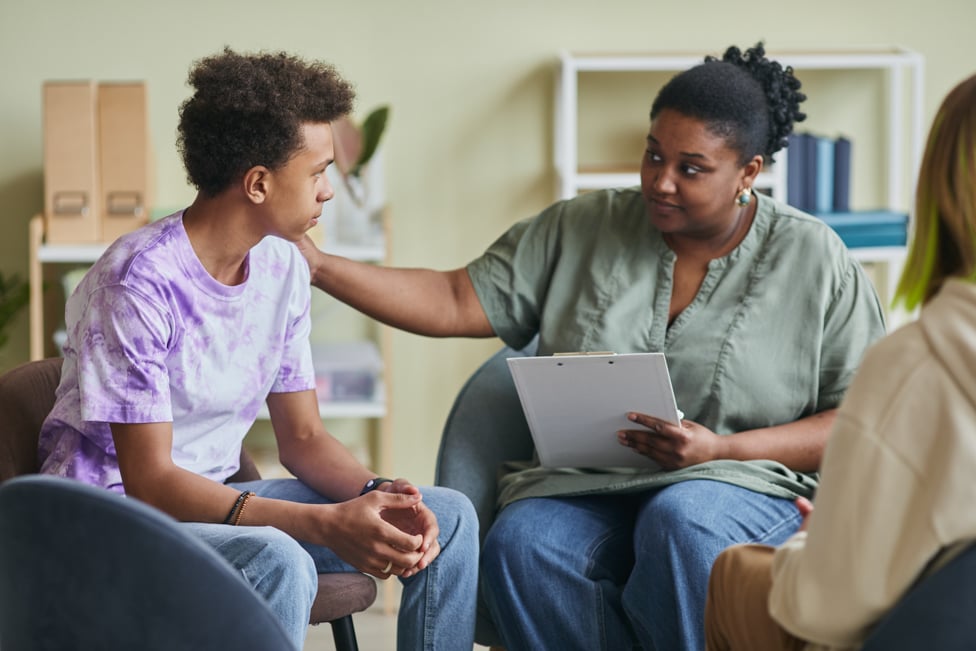 Social worker talking with teenager.