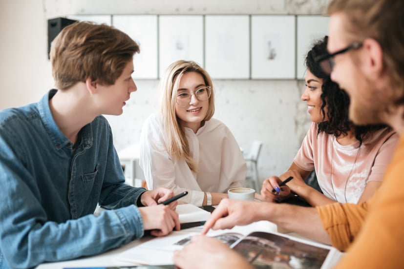 Group of people talking around a table.