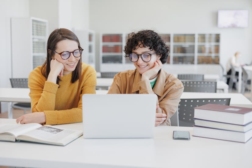 Two women looking at a computer.