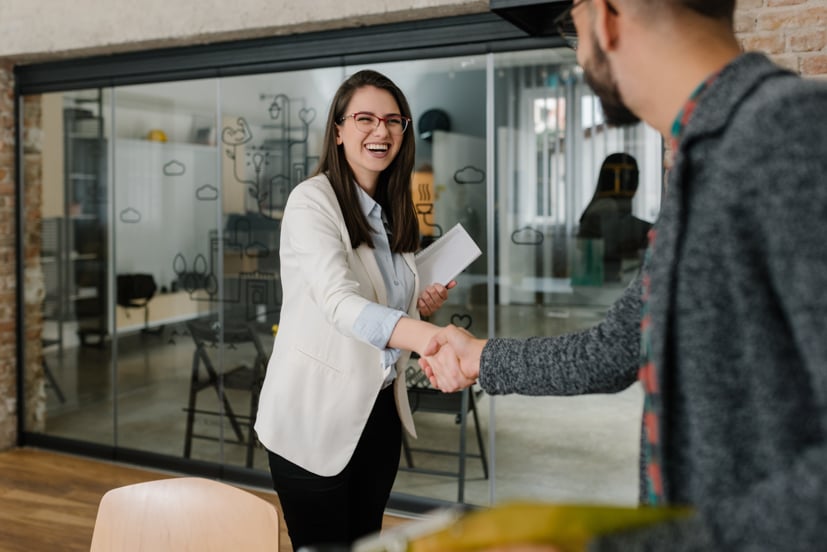 Two women shaking hands.