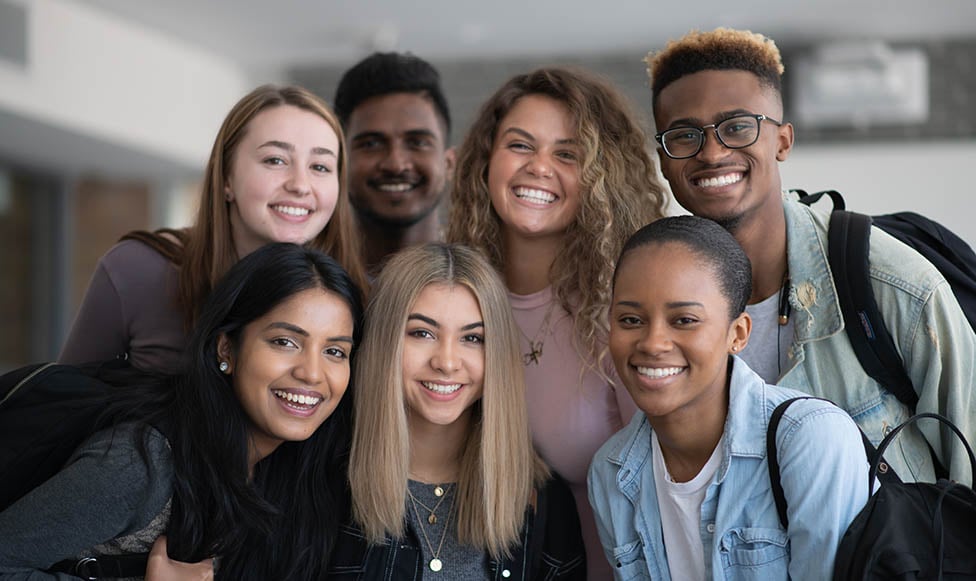 a group of young diverse teachers posing together as a group