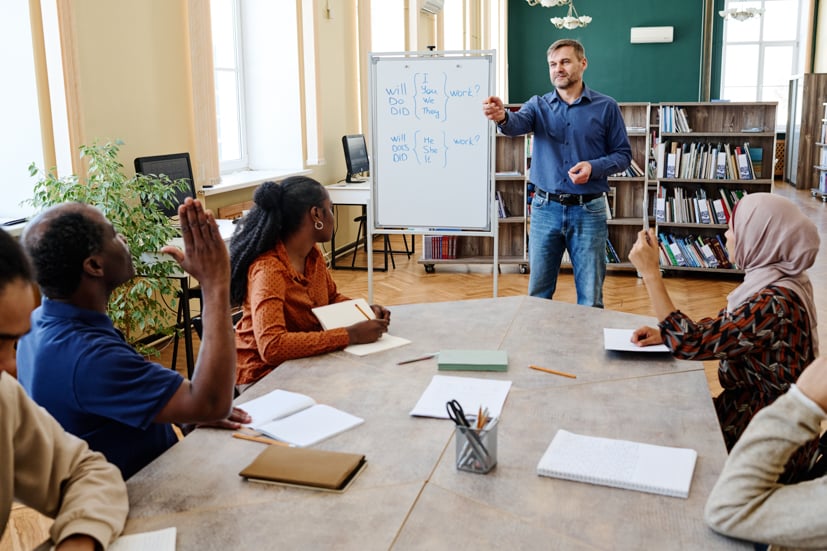 Professor in front of adult students, teaching.