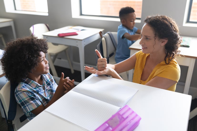 Teacher helping student.